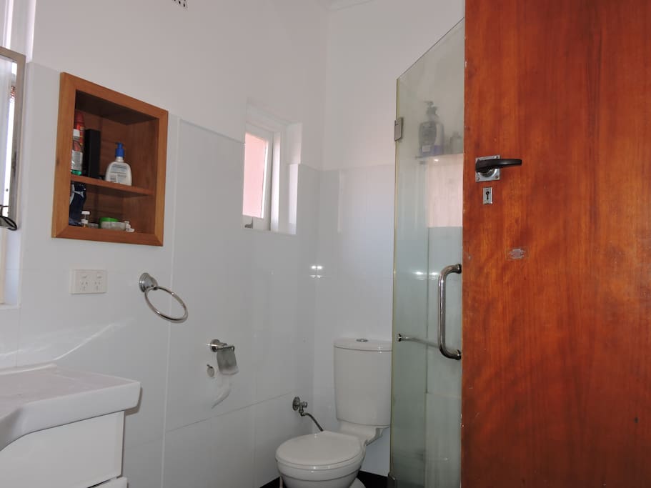 Bathroom has recently been completely renovated with iron bath and glasses shower recces , toilet and vanity. It secures with a key from the inside for privacy. there are two windows and fan light system on ceiling.