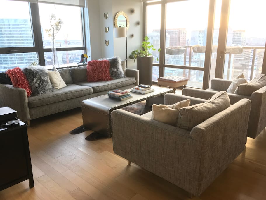 Living room with private balcony overlooking Boston and the Seaport / convention center area.