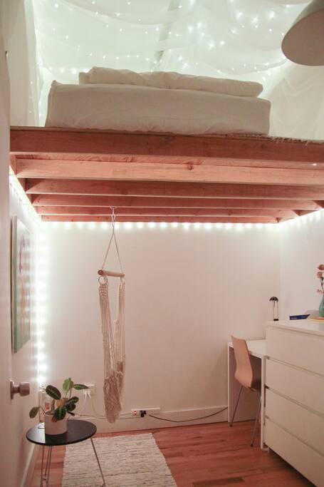 Your room with a hammock, desk, dresser, clothing rack w/hangers, and a Yoshitomo Nara painting.