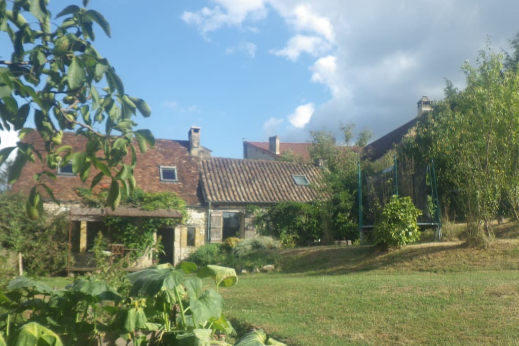 View of the rear side garden, taken from the beginning of the far extending priary. From here we see the terraced side of the house.