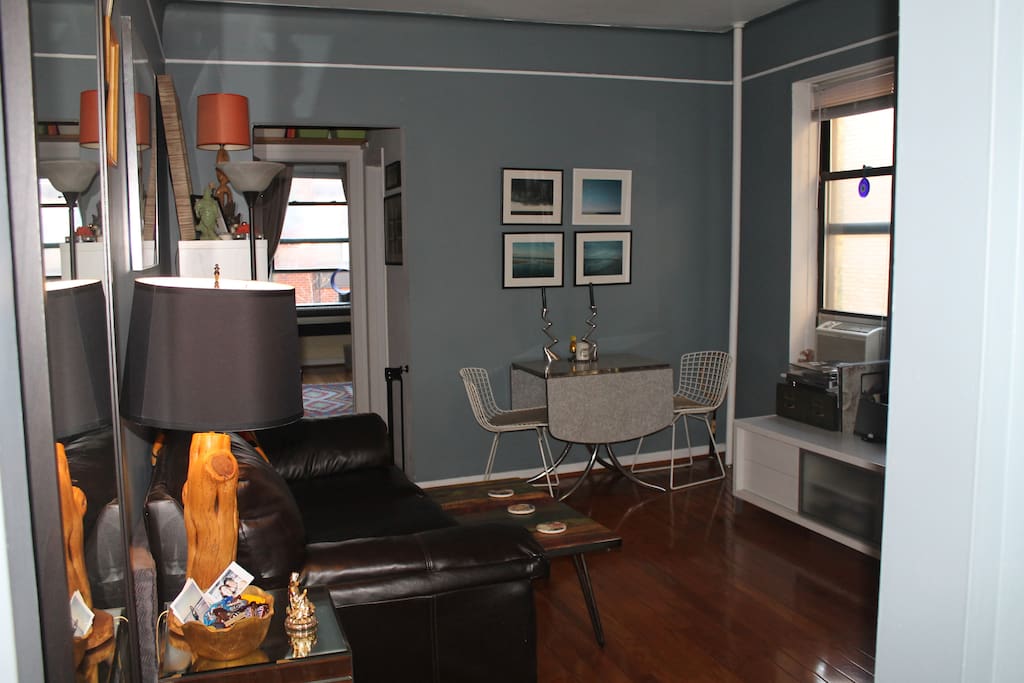 Open cozy living room space with sofa, and dining table