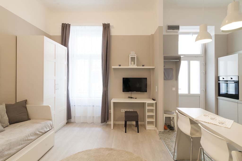 one of the two bedsofa is on the left, TV in the middle