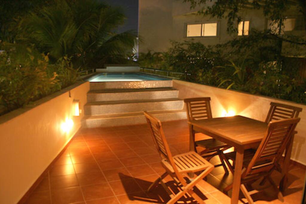 pool on patio with dimmers on at night