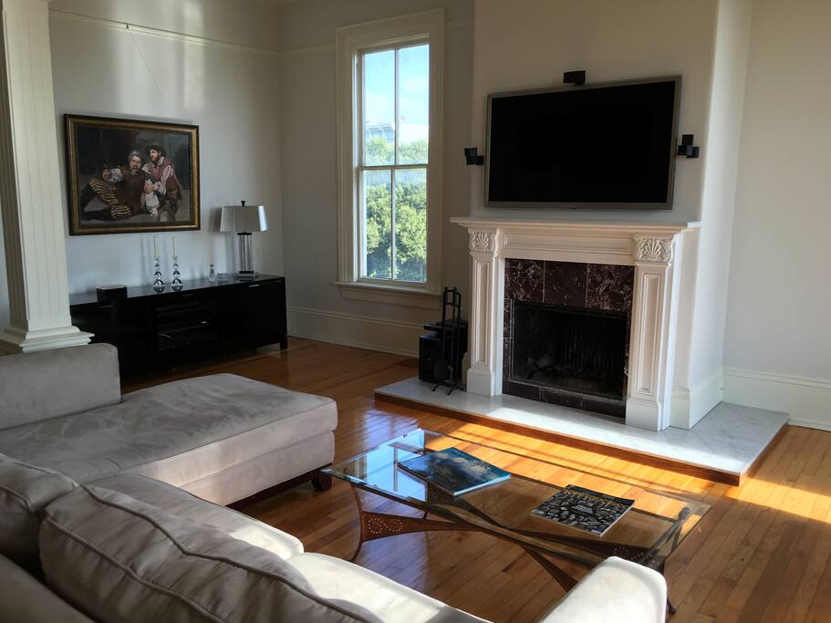 Living room with flat screen TV, Bose surround sound and working fireplace.