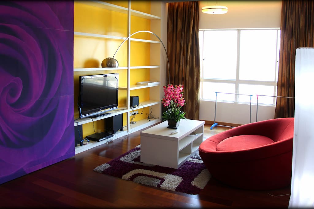 Spacious living room with TV, DVD player, sound theater, and cozy corner.