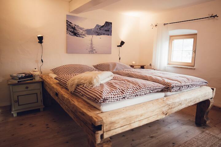 A bedroom in the farmhouse with a queen bed