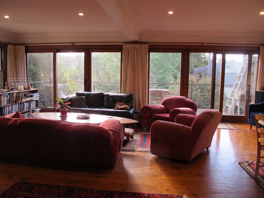 Large living and dining room with outdoor entertaining deck and barbecue.