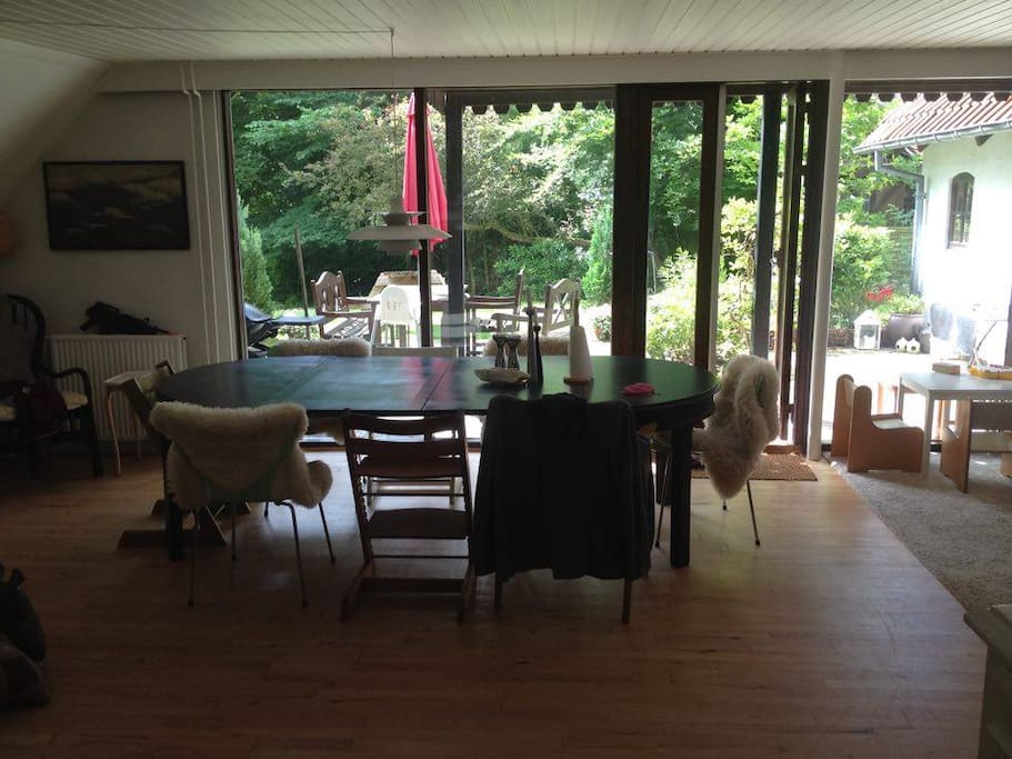Grand living & dining room with fire place, exit to garden and room for 12 people around the table