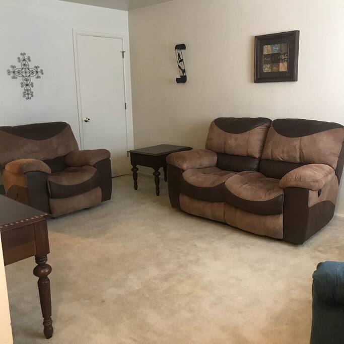 The living room w 2 sofas and one reclining sofa