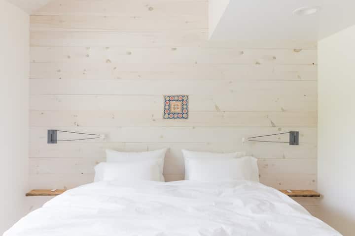 Apartment bedroom #1, king bed. Minimal Scandinavian style.