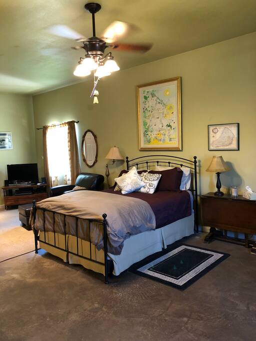 Queen bed with linens.