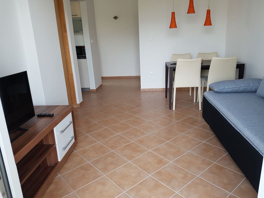 Living area, dining area and a view to entrance, kitchen and bathroom