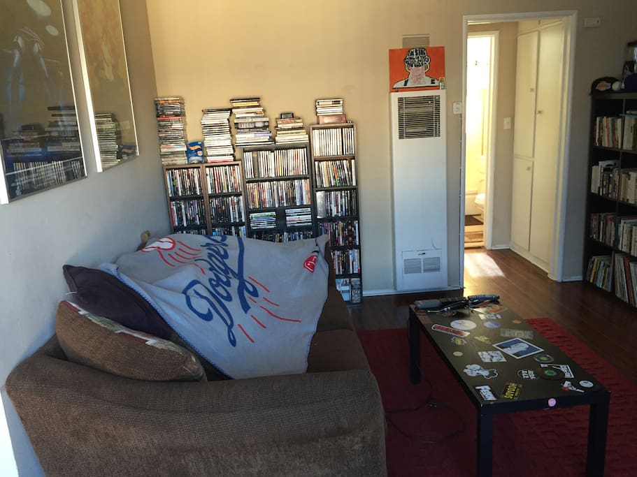 Living room with love seat/couch and may dvds to choose from and watch