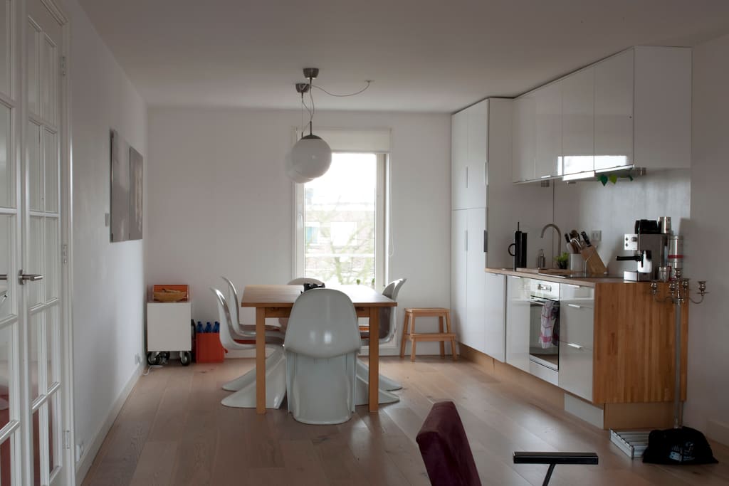 open kitchen and big dining table with view on a big tree in the backyard