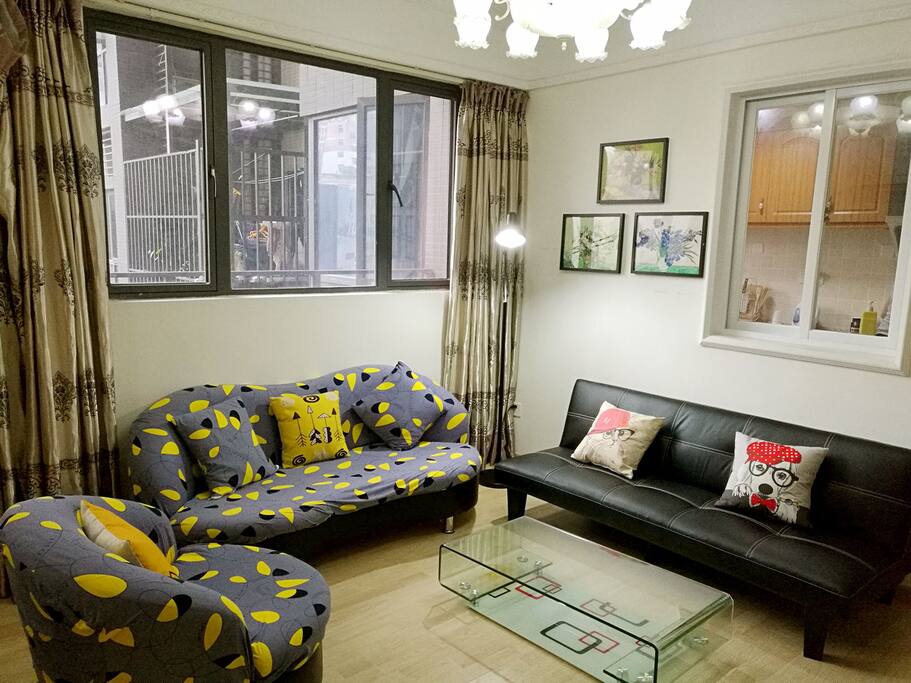 There are three sofas in the living room~one of them is a sofa bed