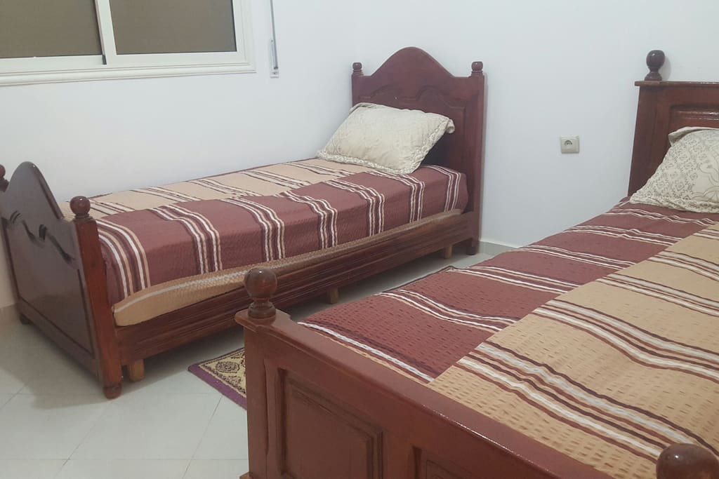 chambre équipée de 2 lits en bois
