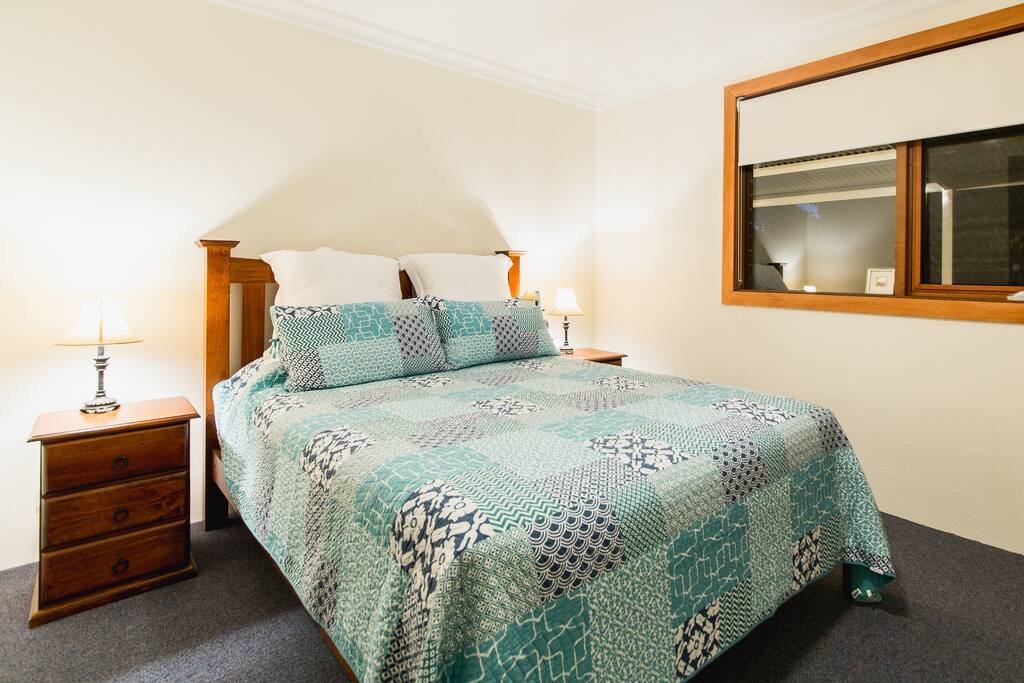 Large Queen Bedroom with built-in robes and luxury linen.