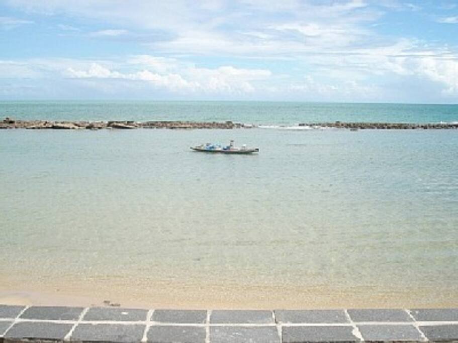 Vista do mar tranquilo, de águas rasas e quentes. Ideal para crianças.