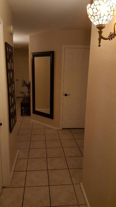 The room is the last door at the end of this hallway. The first door on the left is the bathroom.