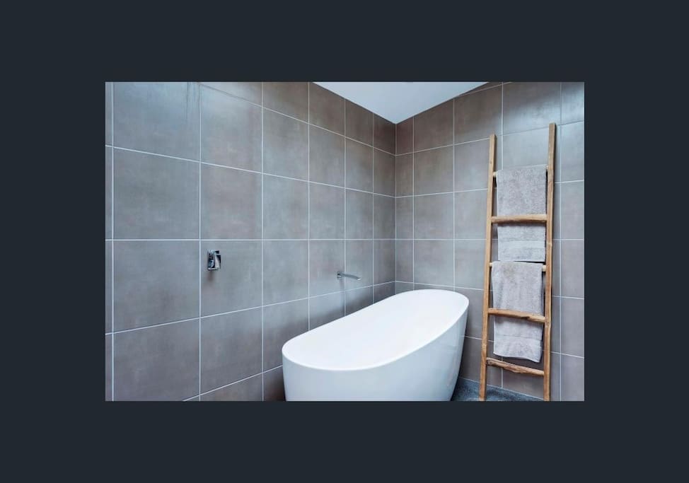 Bathroom - has beautiful tiling, a hot tub and a hot powerful shower