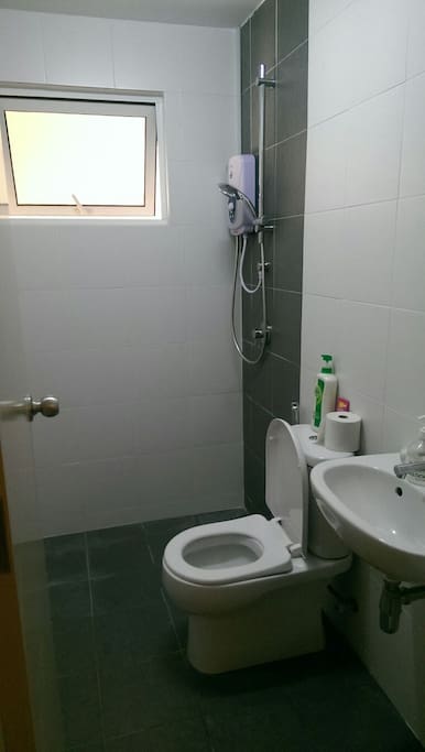 Small bathroom attached with water heater.
