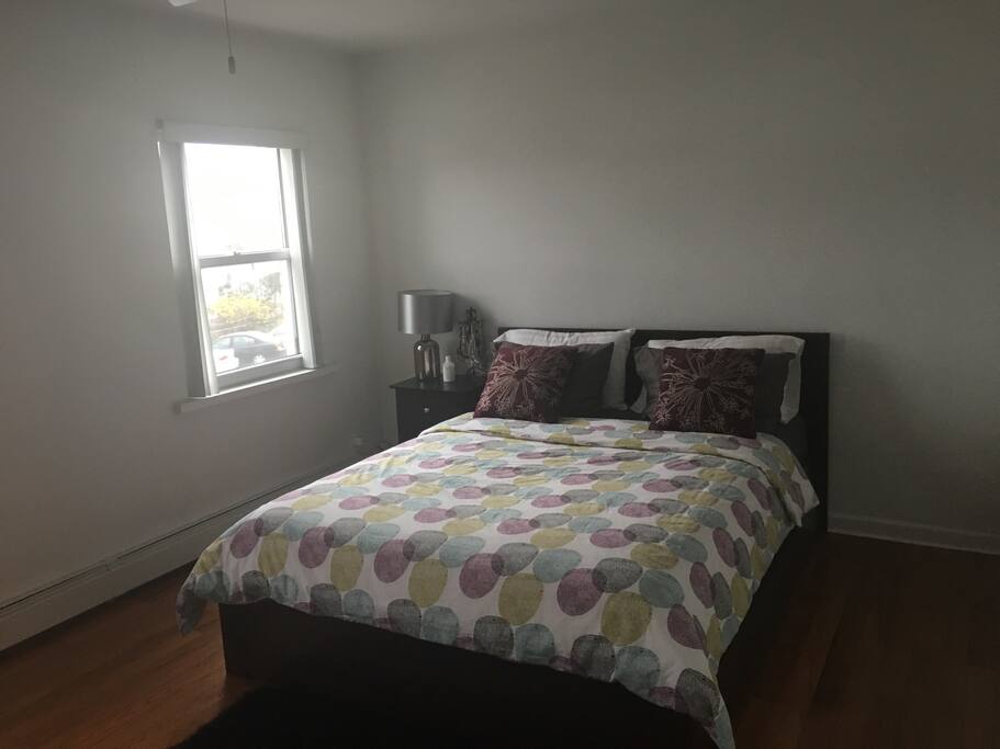 Very spacious bedroom with a queen size bed for two people to fit comfortably.
