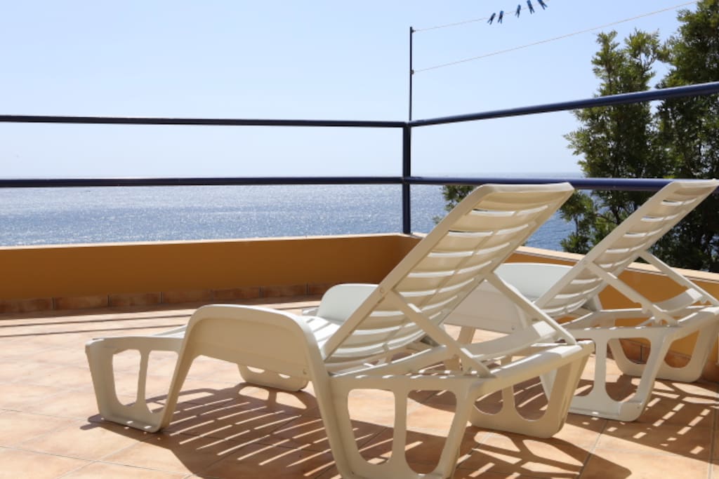 Spacious sunny balcony with chaises lounges for sun lovers