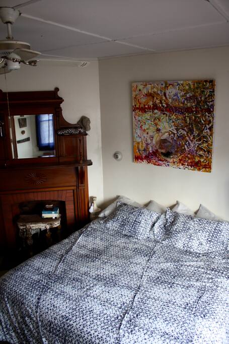 Super comfy king size bed in the large, sunny bedroom.