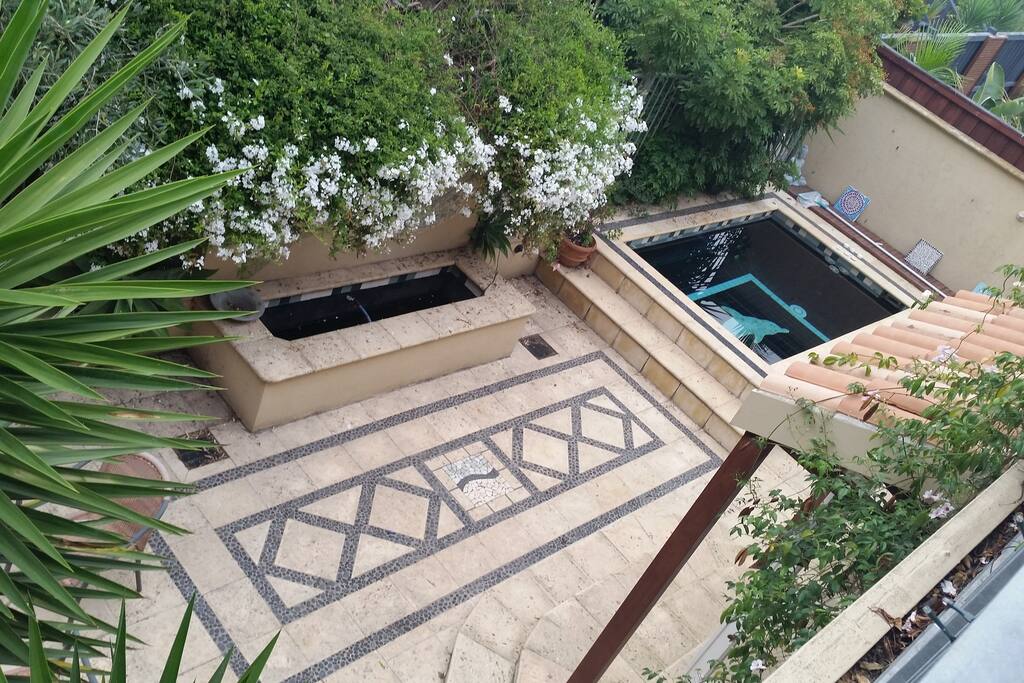 The view of the beautiful landscaped patio area with water feature and spa.