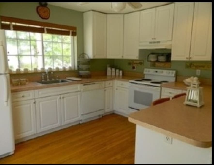 Open bright airy kitchen with an island that seats 4-5ppl