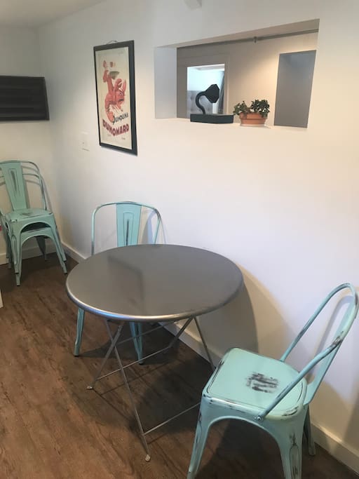 Dining area- 4 stackable chairs and a collapsible round table.