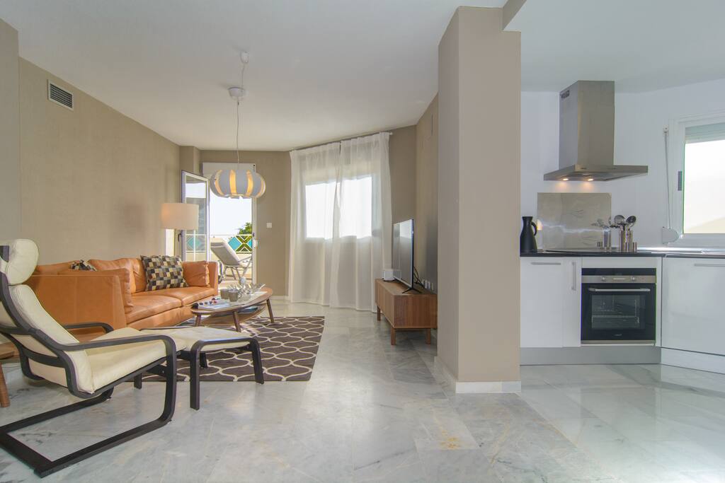 Living room with sitting area and exit to terrace