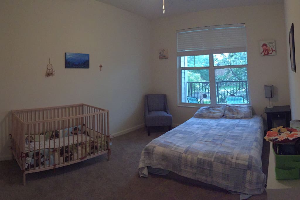 Second bedroom with queen size bed and crib