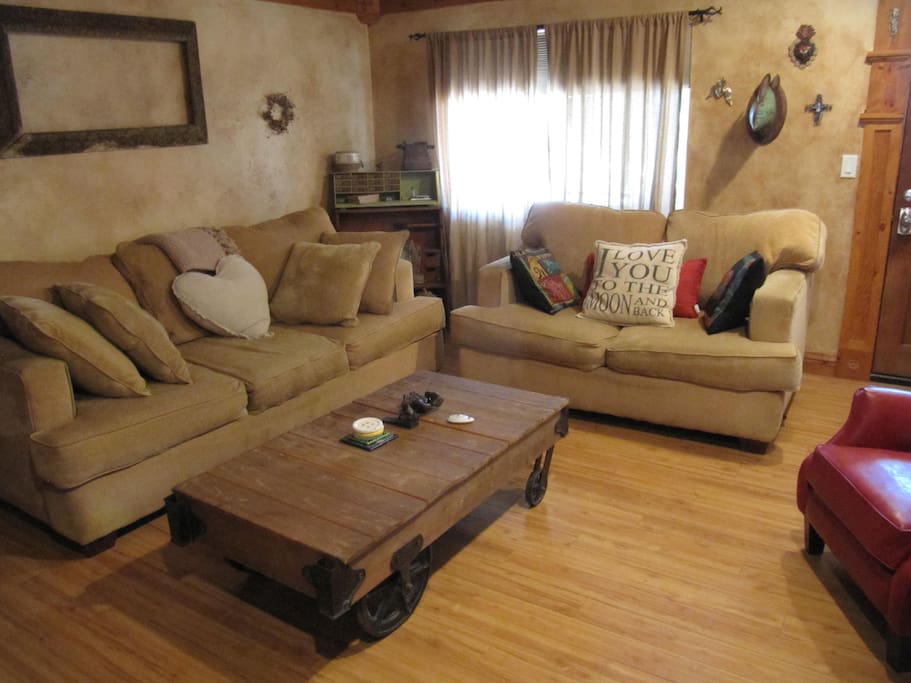 The living room has seating for 6 and art for all