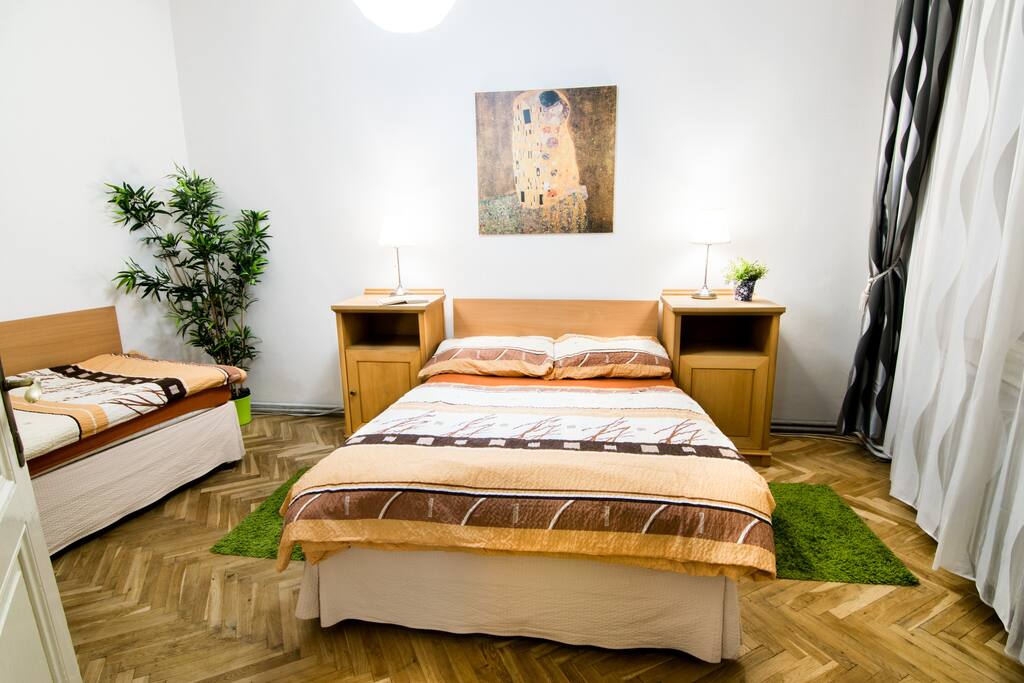 Bedroom with double bed, one single bed and wardrobe.
