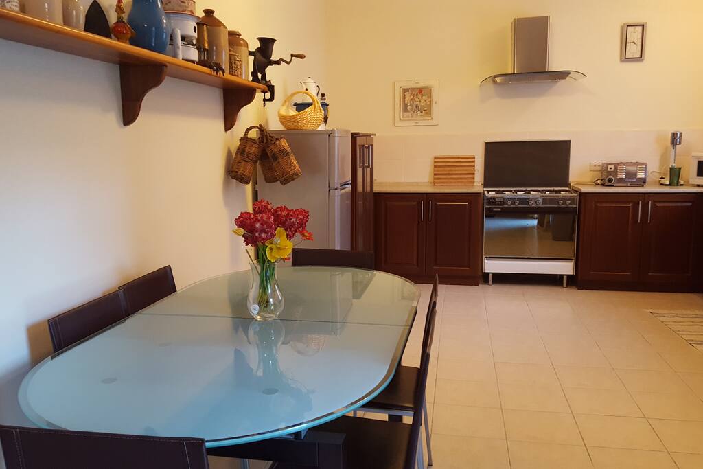 Spacious kitchen and dining area with ceiling fan available.