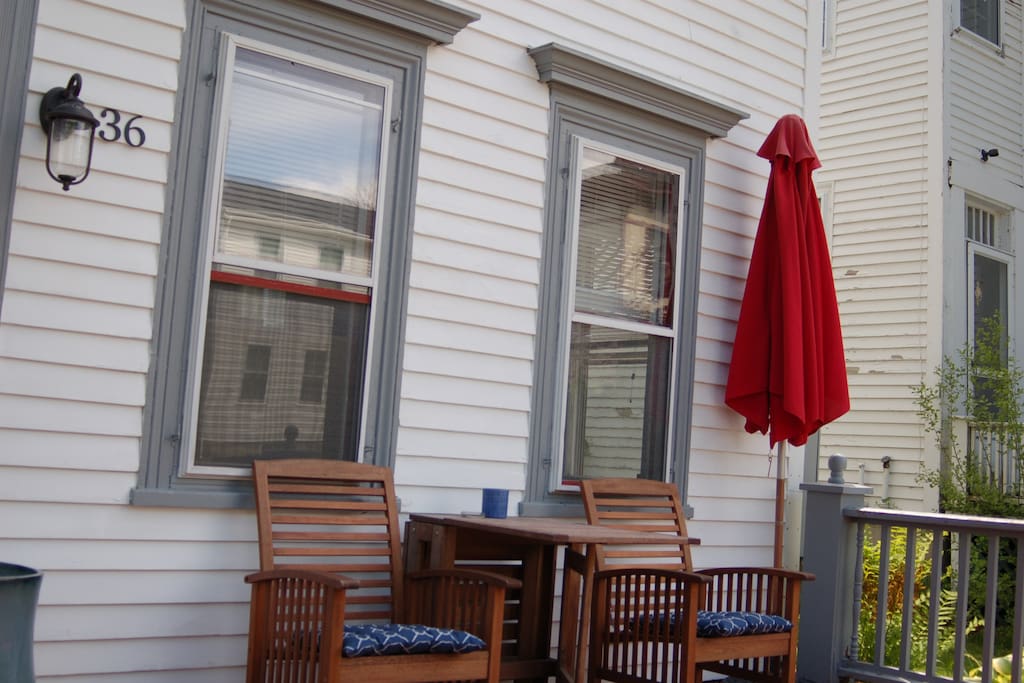 Front porch with seating area for 2, umbrella, and propane BBQ