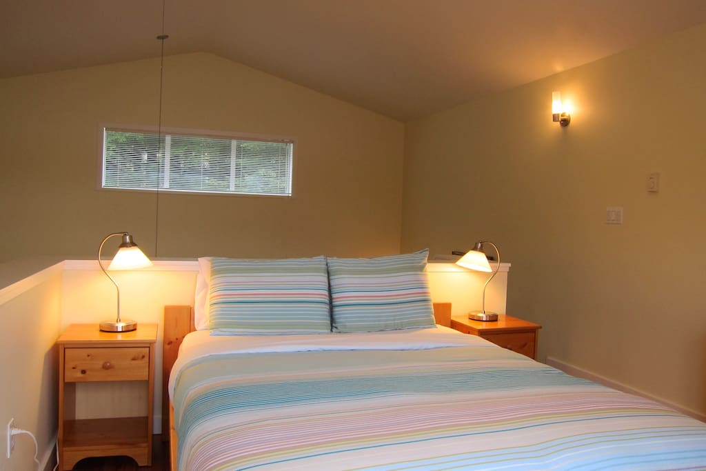 Open concept loft bedroom with comfy queen bed