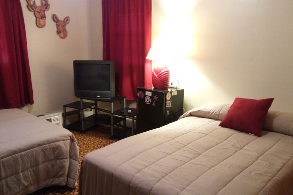 Bdrm #1 : Red bedroom, tv and streaming dvd player, 2 dbl beds with linens and towels, no fridge in room anymore