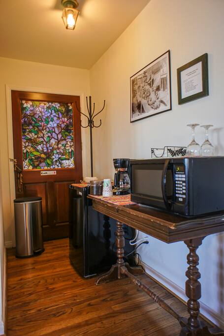 Microwave, Small Refrigerator, Coffee Pot with Coffee Beans to grind your own fresh coffee.