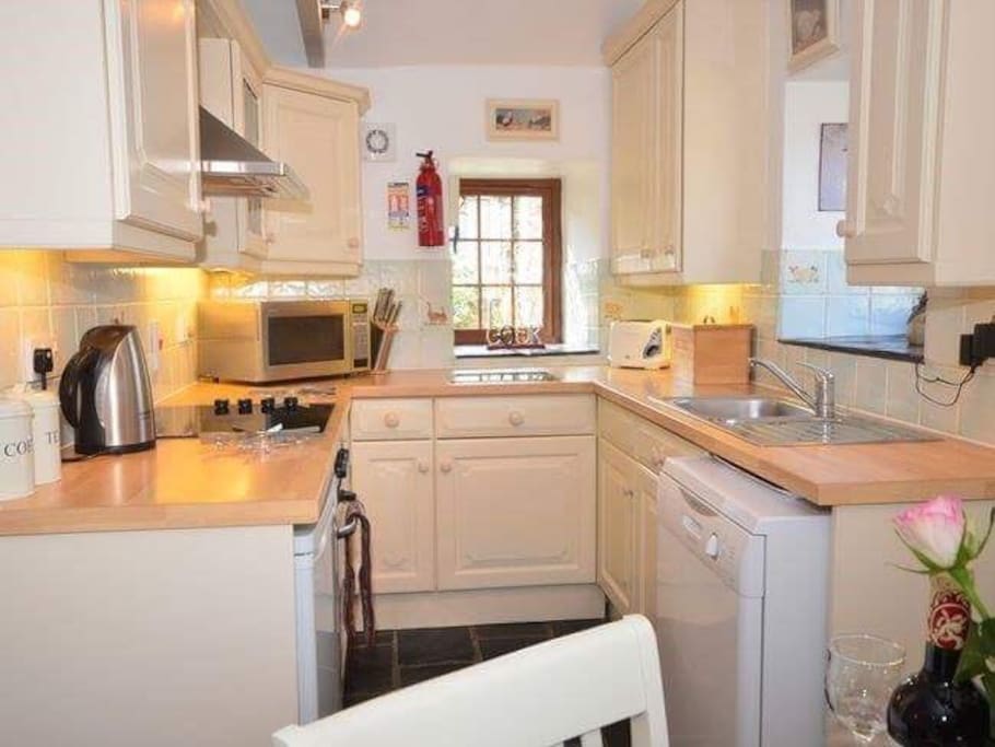 Kitchen with dishwasher, microwave, fan oven, ceramic hob and fridge