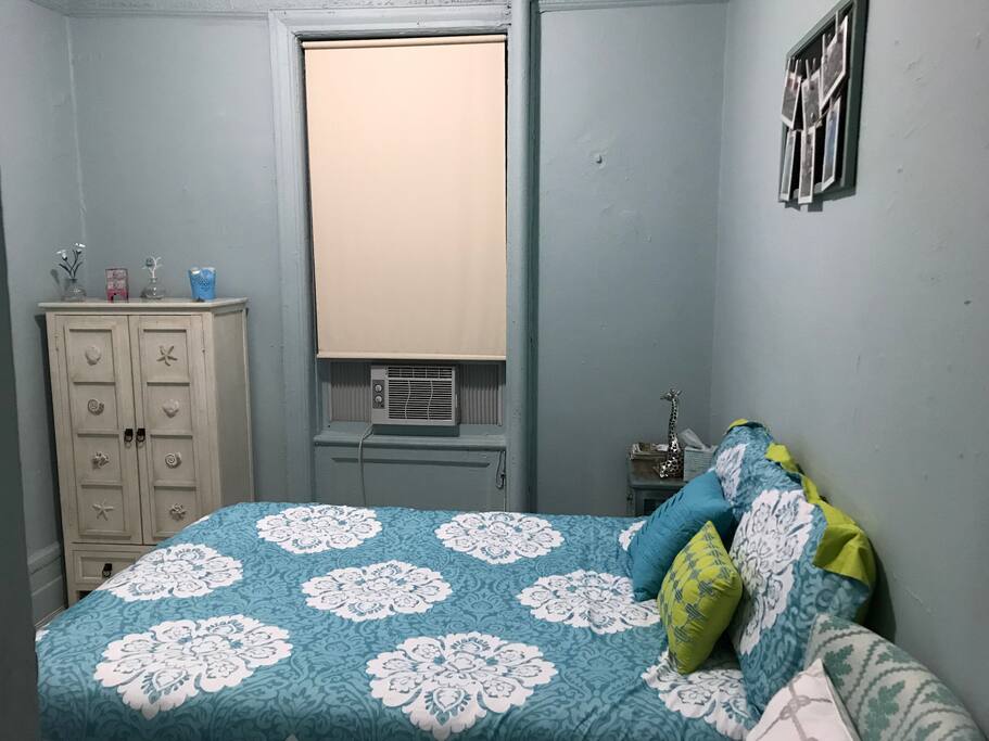 Full size bed, dresser, window, air conditioner, night stand, decorative board.