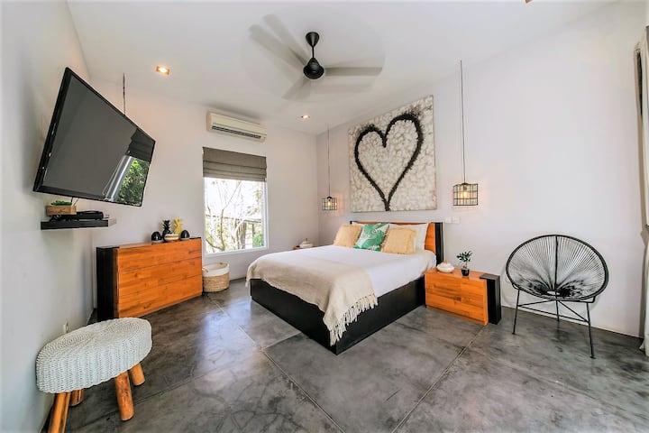 Queensize-Schlafzimmer mit eigenem Bad auf der zweiten Etage.  Führt auf einen überdachten Balkon mit Blick auf Pool und Gärten