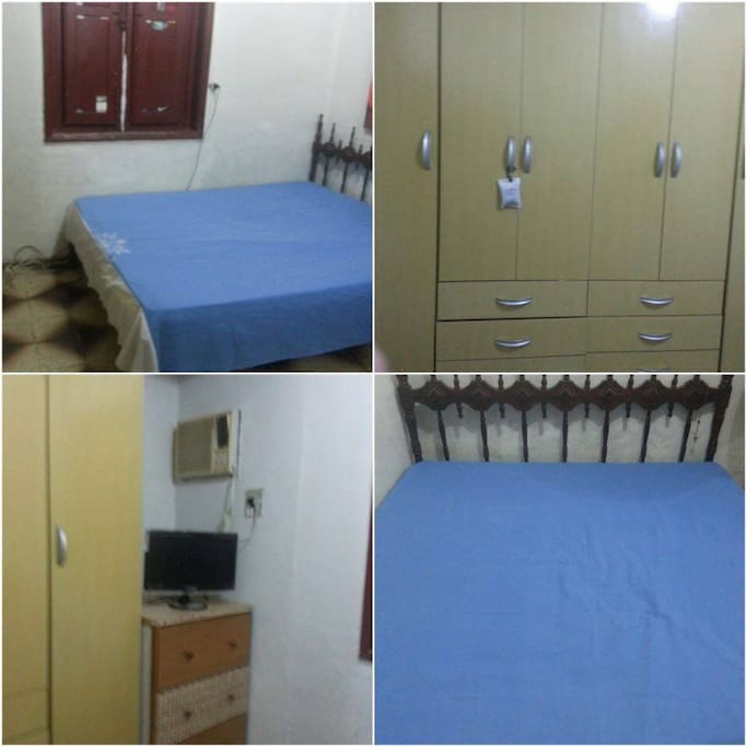 quarto com cama de casal,armário e tv