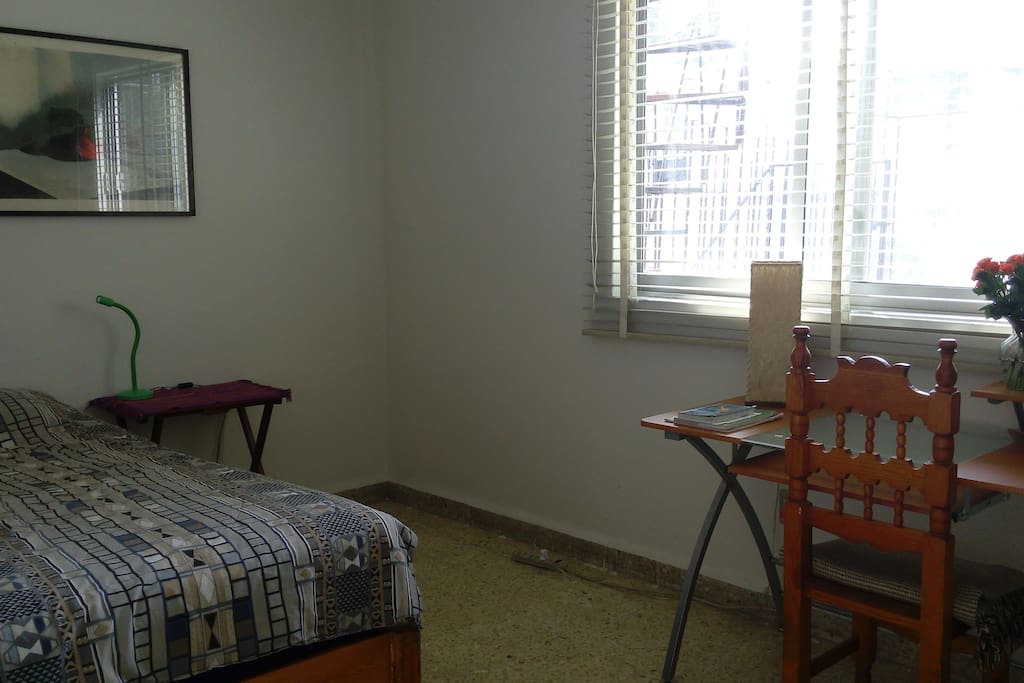 New arrangement of the room with desk and double bed.
