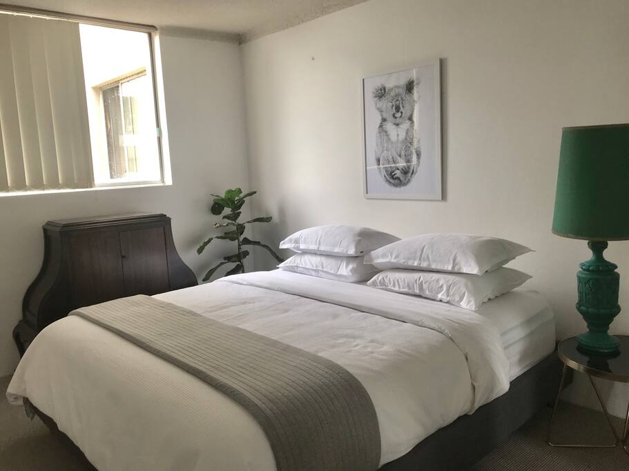 Main bedroom with king size bed and a built in wardrobe.