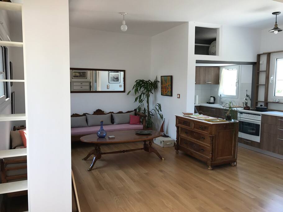 Living room and aspect of the kitchen.