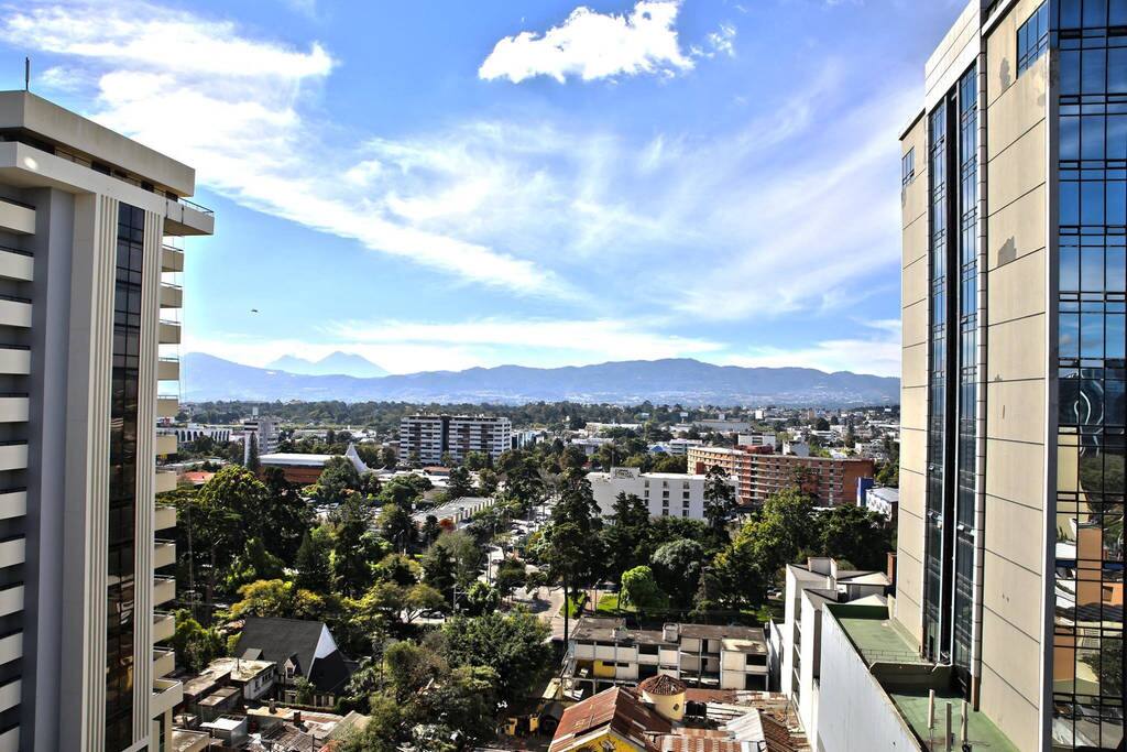 Beautiful skies as you look out of the balcony window. In the background you can see volcanoes, Agua, Fuego, and Acatenango.