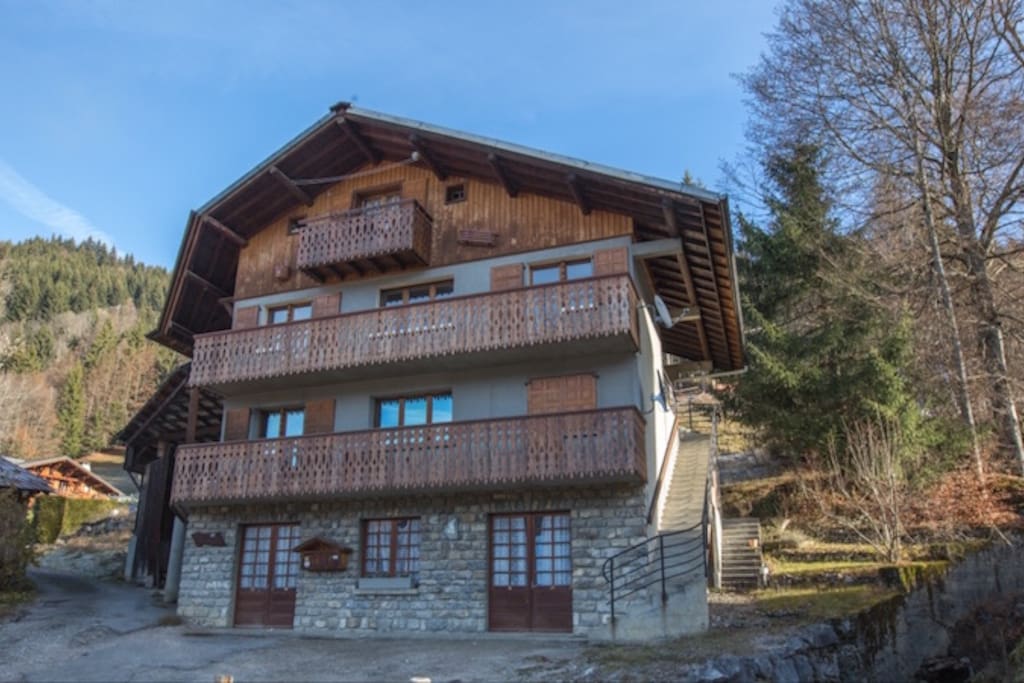 The flat is accessed through the stairs on the right of the chalet