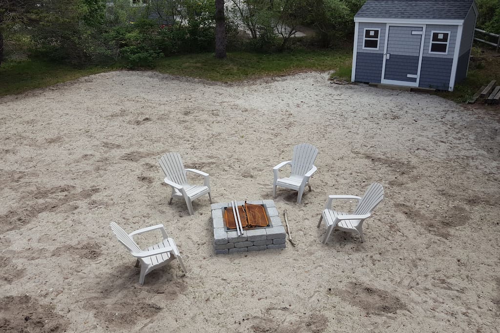 Sandy backyard and fire pit